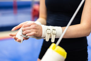 
                  
                    Load image into Gallery viewer, Reisport® Women&amp;#39;s Hyper Protec Uneven Bar Grips being applied to hands
                  
                